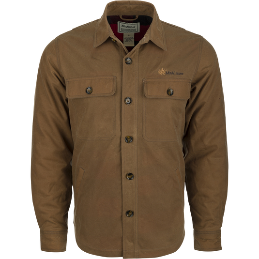 A brown waxed cotton jacket with buttons, featuring a heritage look and a functional fit. Water and wind-resistant, with a bi-swing back pleat and fleece-lined hand pockets. Perfect for outdoor activities.