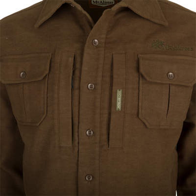 A brown jac-shirt with pockets, featuring windproof protection, 4-way stretch, and an oversized fit.