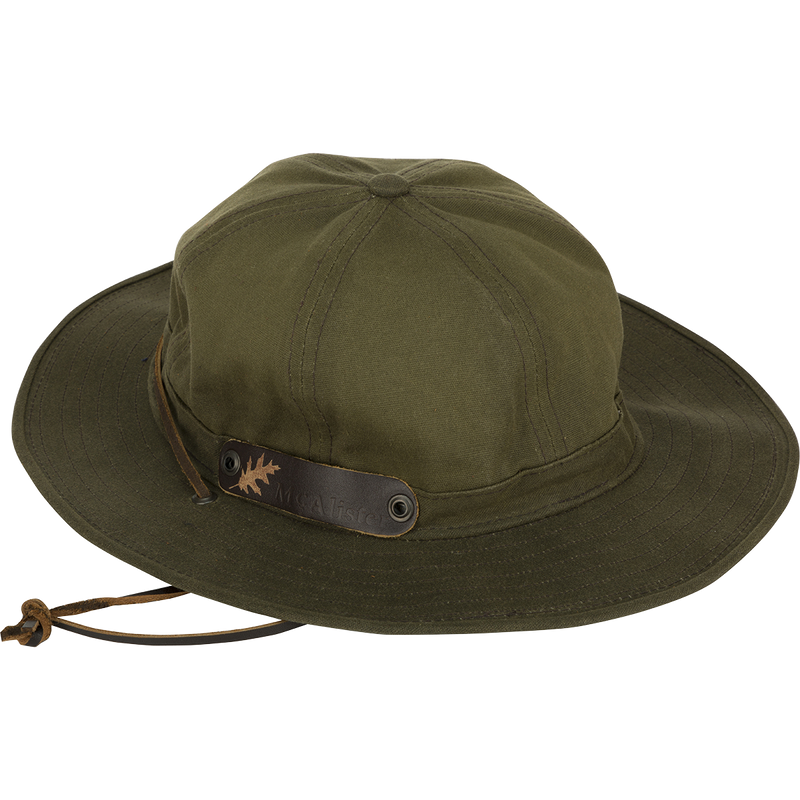 A McAlister Waterfowler's Hat, made of 10.10 oz Waxed Canvas with a cotton lining. Features a shapable brim, leather chin strap, and ventilation grommets.