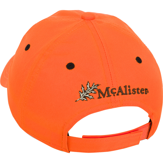 McAlister Upland Circular Patch Twill Cap: A low-profile ball cap with an orange fabric, black dots, and a leaf. Adjustable Velcro closure for a perfect fit.