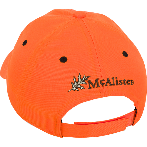 McAlister Upland Embroidered Twill Cap: A low-profile ball cap with an orange fabric featuring a black dotted pattern and a leaf. Adjustable Velcro closure for a perfect fit.