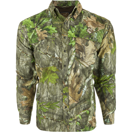 A close-up of a camouflage-patterned long-sleeved shirt with a mesh back panel and large chest pockets. The shirt is made of lightweight, breathable polyester and features a removable spine pad for increased comfort while hunting.
