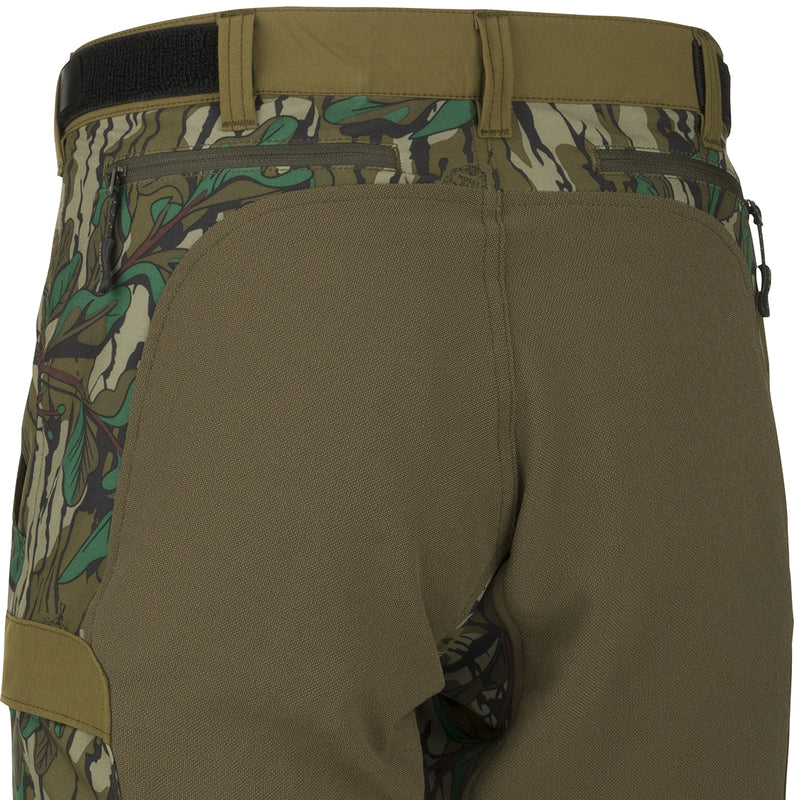 A close-up of the Women's Tech Stretch Turkey Pant, featuring reinforced knees, ankles, and bottom. Designed for spring turkey hunting, these lightweight, moisture-wicking pants offer 4-way stretch and a relaxed fit for comfort on the move or when seated. Mesh pockets, zippered back pockets, and cargo pockets provide ample storage.