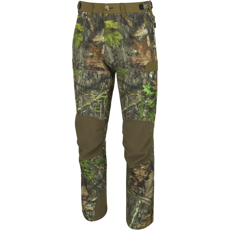 A pair of Men's Tech Stretch Turkey Pants, designed for spring turkey season. Lightweight, moisture-wicking, and abrasion-resistant with 4-way stretch technology. Features reinforced knees, ankles, and bottom, gusseted crotch for comfort, and adjustable waistband. Mesh and zippered pockets for ventilation and storage. Ideal for hunting and staying concealed in the woods.