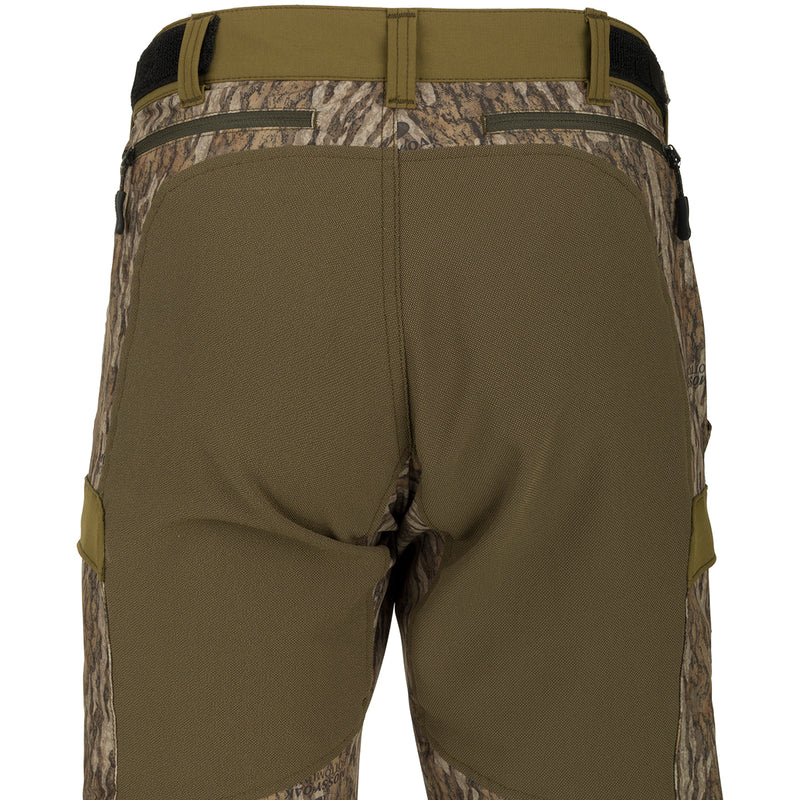 A pair of men's Tech Stretch Turkey Hunting Pants, featuring a camouflage design. Made of lightweight, moisture-wicking fabric with reinforced knees and ankles for durability. Perfect for spring turkey season.