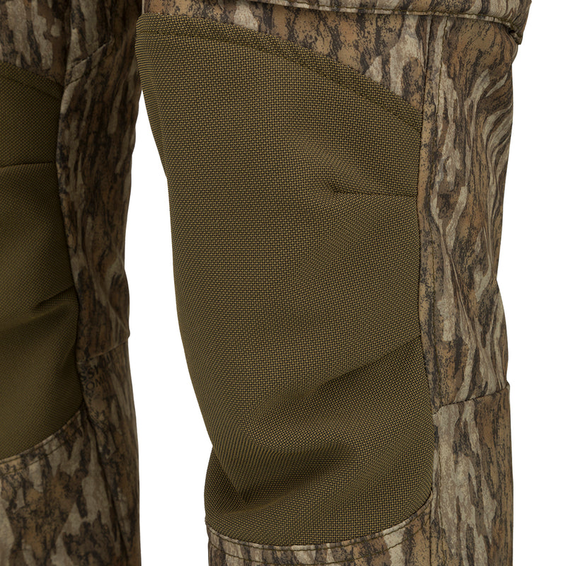 A close-up of the Men's Tech Stretch Turkey Hunting Pant, showcasing its durable fabric and reinforced knees. Perfect for spring turkey season, these pants offer moisture-wicking and 4-way stretch technology. Stay comfortable and concealed in the woods with a relaxed fit, gusseted crotch, and adjustable waistband. Mesh and zippered pockets provide ventilation and storage for your hunting essentials.