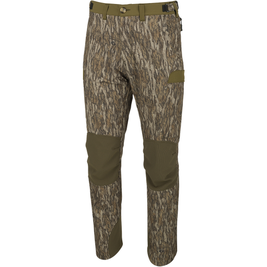 A close-up of the Youth Tech Stretch Turkey Pant, a pair of camouflage pants with reinforced knees, ankles, and bottom. Designed for comfort and durability, these pants feature a gusseted crotch and adjustable waistband. Mesh pockets and cargo pockets provide storage and ventilation. Perfect for hunting and outdoor activities.