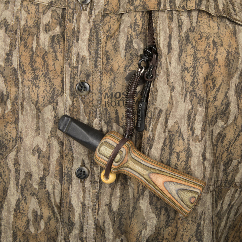 Mesh Back Flyweight Shirt with Spine Pad: A close-up of a lightweight, breathable hunting shirt with a knife and strap attached.