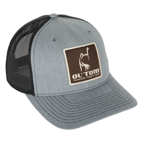 Ol' Tom Mesh Back Patch Cap with a grey hat, black mesh cap, and brown square patch with white text. Features 6-panel construction, structured front panels, and adjustable snapback.
