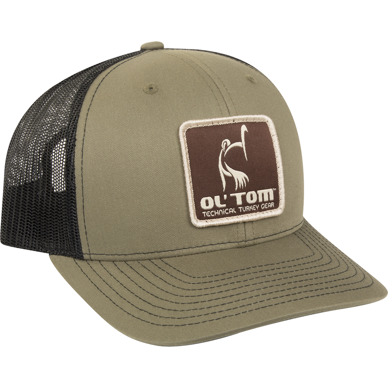 Ol' Tom Mesh Back Patch Cap with a green and black hat featuring a logo patch embossed across the front.