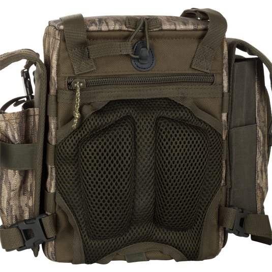 A close-up of the Turkey Chest Pack, a durable and lightweight bag made with 600D Polyester. Features include a removable bino harness, multiple pockets and loops, and a stowable rain fly for protection. Perfect for your next hunting trip.
