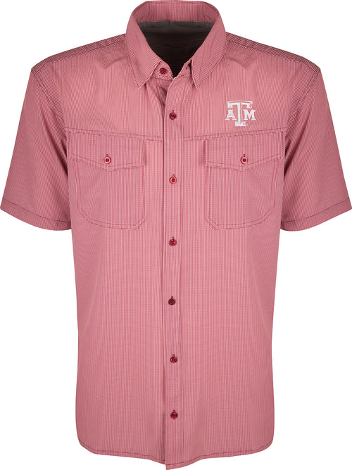 A red and white checkered shirt with collar and button details. Made of lightweight, breathable poly/spandex fabric with four-way stretch for freedom of movement. Ideal for early season football games or weekend tailgates. Features moisture-wicking and wrinkle-resistant construction. Texas A&M logo embroidered on the left chest.