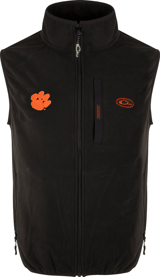 Clemson Camp Fleece Vest with windproof layering, featuring a black vest with orange logo. Stand-up collar, Magnattach™ pocket, and hand warmer pockets.