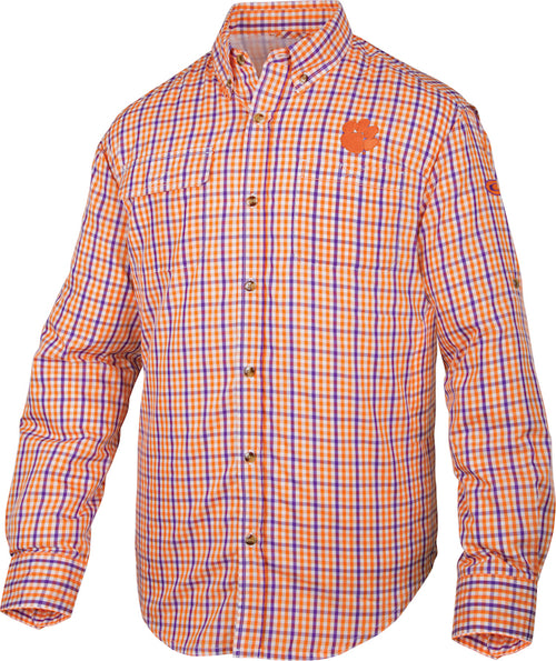 Clemson Gingham Plaid Wingshooter's Shirt L/S: A new, long-sleeved shirt with a plaid pattern in orange and white. Made of polyester and nylon, it's perfect for cool Fall mornings or football games. Features include a vented mesh back and large chest pockets.