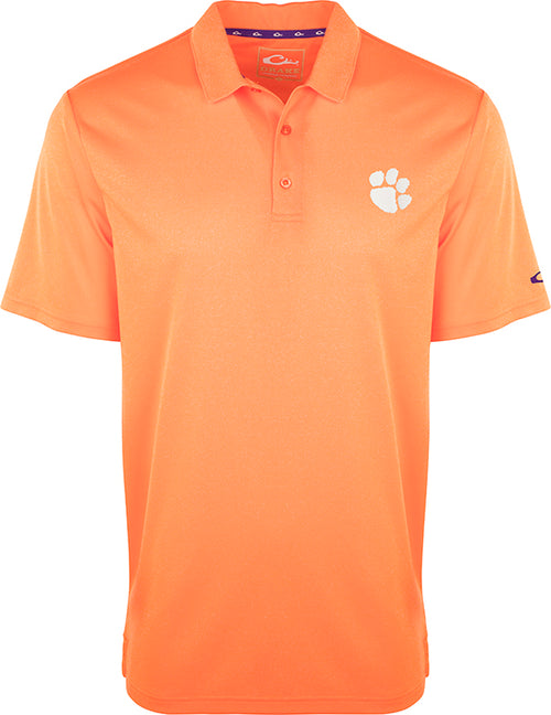 Clemson Vintage Heather Polo: An orange polo shirt with a paw print, perfect for any Tiger fan. Four-way stretch, quick-drying, moisture-wicking, and breathable. Official Clemson logo on left chest.