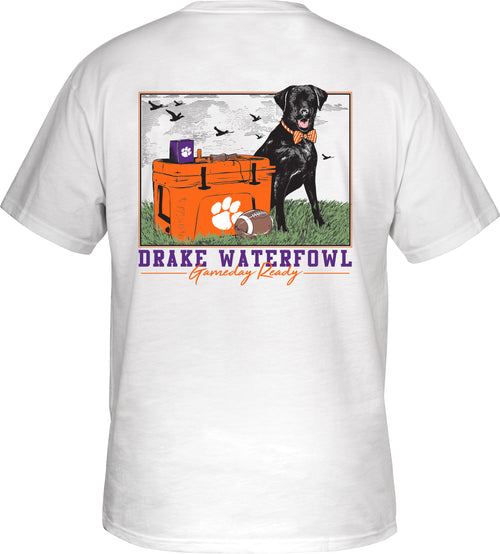 A black labrador retriever stands beside a cooler, ready for game day on the Clemson Black Lab Tailgate T-Shirt.
