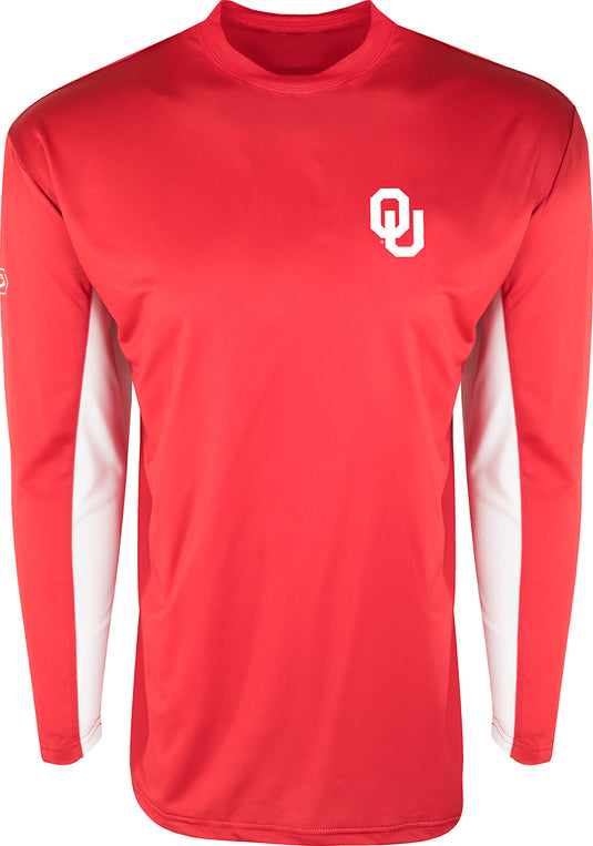 Alt text: Oklahoma L/S Performance Crew, a red long-sleeved active shirt with a white logo. Features breathable mesh on back and underarms, Shield 4™ technology for sun protection.