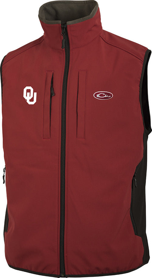A lightweight, windproof tech vest with University of Oklahoma logo embroidery on the right chest. Made of 100% polyester with a bonded fleece lining. Features vertical Magnattach™ chest pocket, zipper closures on chest and lower pockets, and side stretch panels. Perfect for blocking out the wind and layering. Ideal for hunting, fishing, and outdoor activities.
