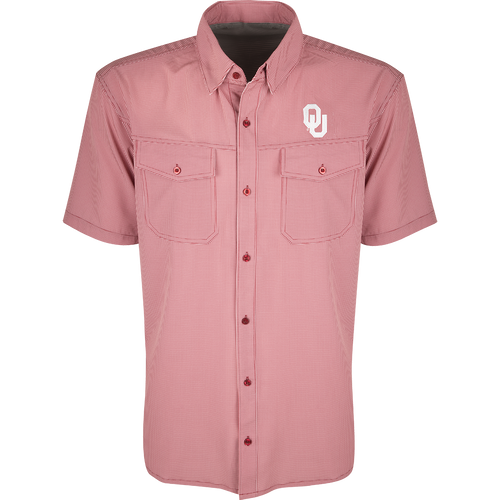 A red and white checkered shirt with collar and button flaps. Made of lightweight, breathable poly/spandex fabric with four-way stretch. Ideal for football games or weekend tailgates. Features moisture-wicking and wrinkle-resistant construction. Oklahoma logo embroidered on the left chest.