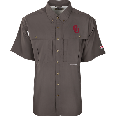 A close-up of the Oklahoma S/S Flyweight Wingshooter shirt, featuring a logo, vented back design, and multiple pockets. Lightweight, breathable, quick-drying, and moisture-wicking, this shirt is perfect for warm-weather outdoor activities. Made of 100% polyester with UPF 50+ sun protection.