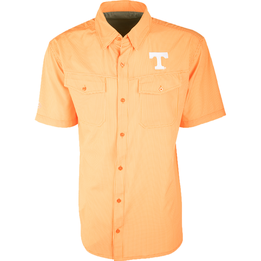 Tennessee S/S Traveler's Shirt with orange and white design, featuring a white letter T. Lightweight, breathable fabric with four-way stretch for freedom of movement. Ideal for early season football games or weekend tailgates. Moisture-wicking and wrinkle resistant. Embroidered Tennessee logo on left chest.