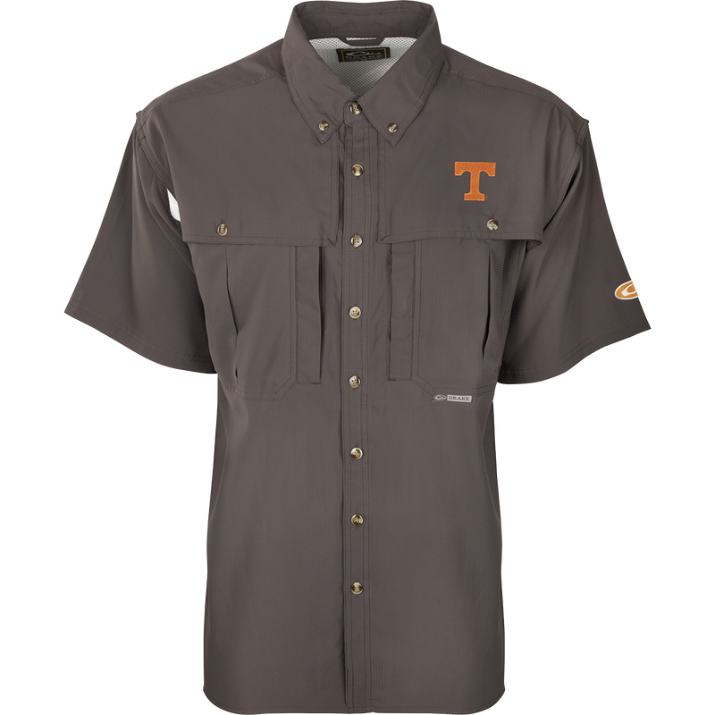 Tennessee S/S Flyweight Wingshooter: A grey shirt with a logo, designed for warm-weather outdoor activities. Made of ultra-lightweight polyester fabric for quick-drying and moisture-wicking. Features UPF 50+ sun protection, vented back, Magnattach™ chest pocket, and a vertical zipper pocket.