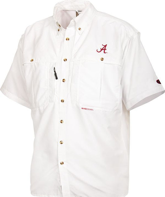 A white button-up shirt with a logo, perfect for Game Day. Breathable, cool, and quick-drying. Features include front and back ventilation, oversized chest pockets, and a Magnattach™ pocket. Alabama Wingshooter's Shirt S/S.